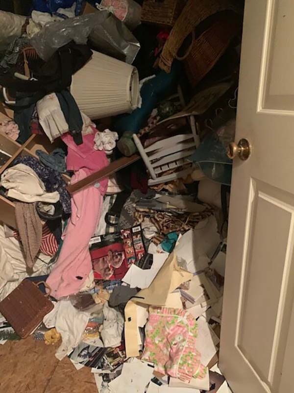 Opened closet door showing potential hoarding behaviors